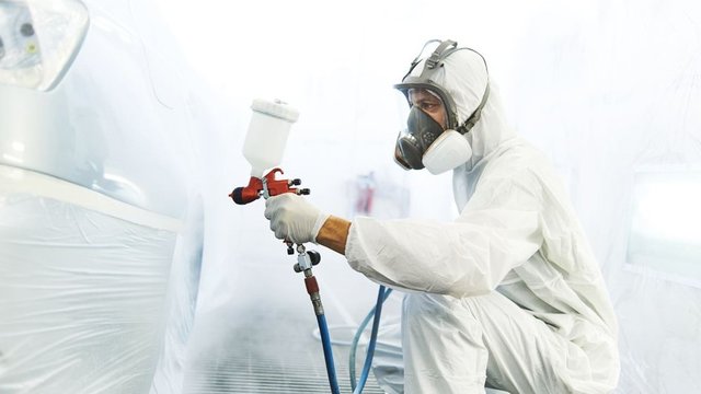 car painter in protective suit